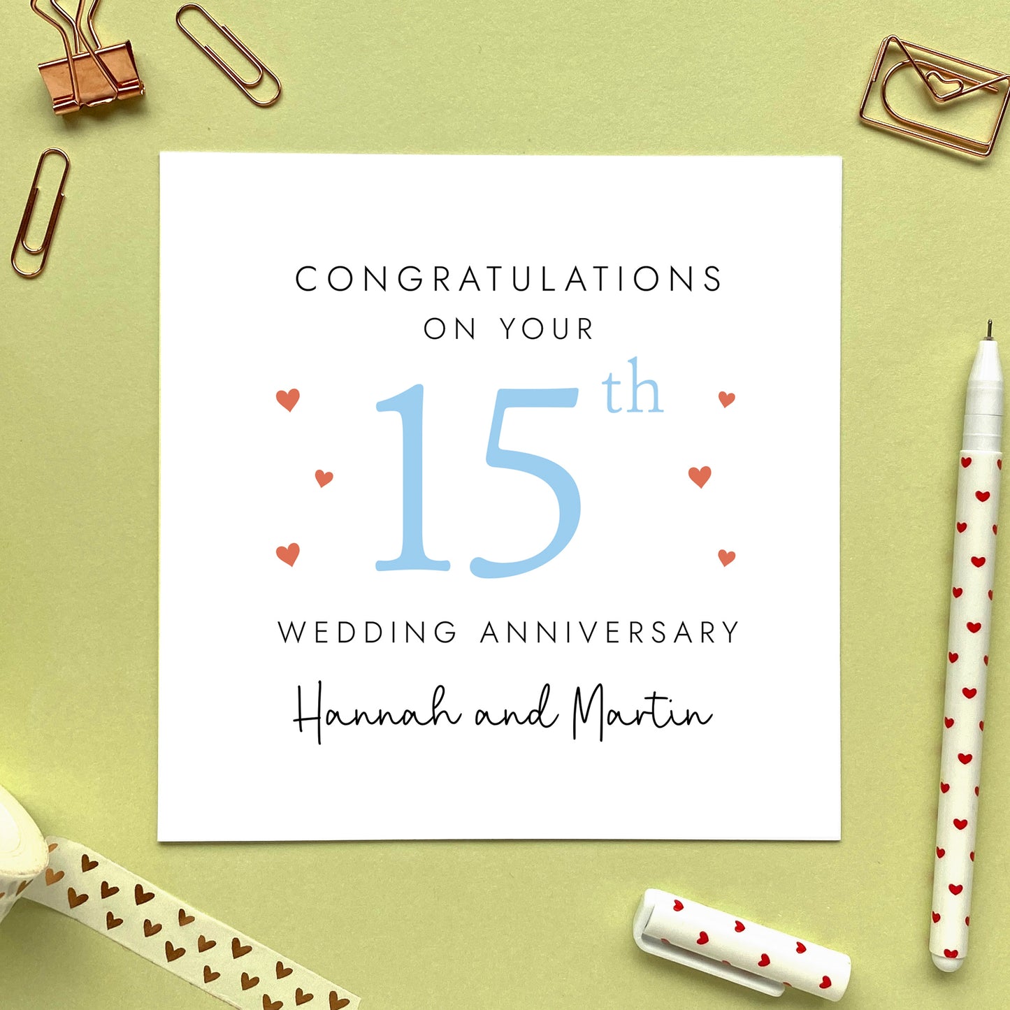 A personalised 15th wedding anniversary card for couple. It features '15th' in pale blue with red hearts, the colour scheme matches the theme of crystal. The text reads 'Congratulations on your 15th wedding anniversary'. This card can be personalised with two names, and is suitable for special friends and family relations such as Daughter and Son-in-Law and Son and Daughter-in-Law. It is also suitable for gay and lesbian couples.