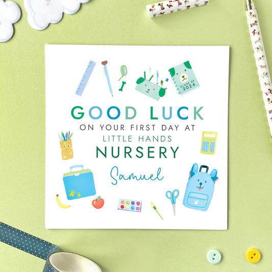 A personalised first day at nursery card for boy, featuring a variety of school themed objects in blue and green. It can be personalised with a child's name and school. It is also suitable for 1st day at primary school, secondary school, nursery and infant school. It is ideal for relations such as son, grandson, little boy, nephew, godson, brother and cousin.