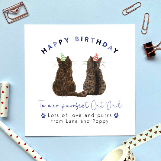 A personalised cats birthday card for Cat Dad where you can choose the two cats on the card. You can choose from a range of different cat breeds and colours, including ginger, black, tabby, ragdoll, grey and bengal cats. It can be personalised with the cat's names to make a from the cats birthday card. The cats in the photo are a tortoiseshell black and ginger cat and a brown tabby cat.