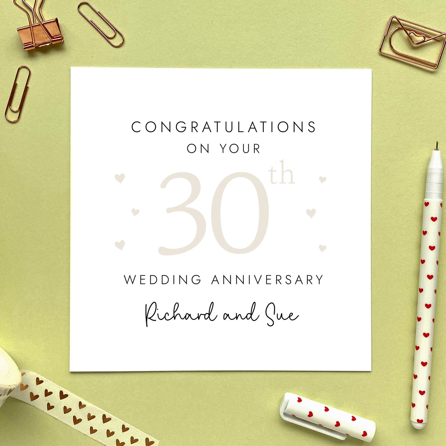 A personalised 30th wedding anniversary card for couple. It features '30th' in pale cream with hearts, the colour scheme matches the theme of pearl. The text reads 'Congratulations on your 30th wedding anniversary'. This card can be personalised with two names, and is suitable for special friends and family relations such as parents, grandparents, Mum and Dad, Daughter and Son-in-Law and Son and Daughter-in-Law. It is also suitable for gay and lesbian couples.