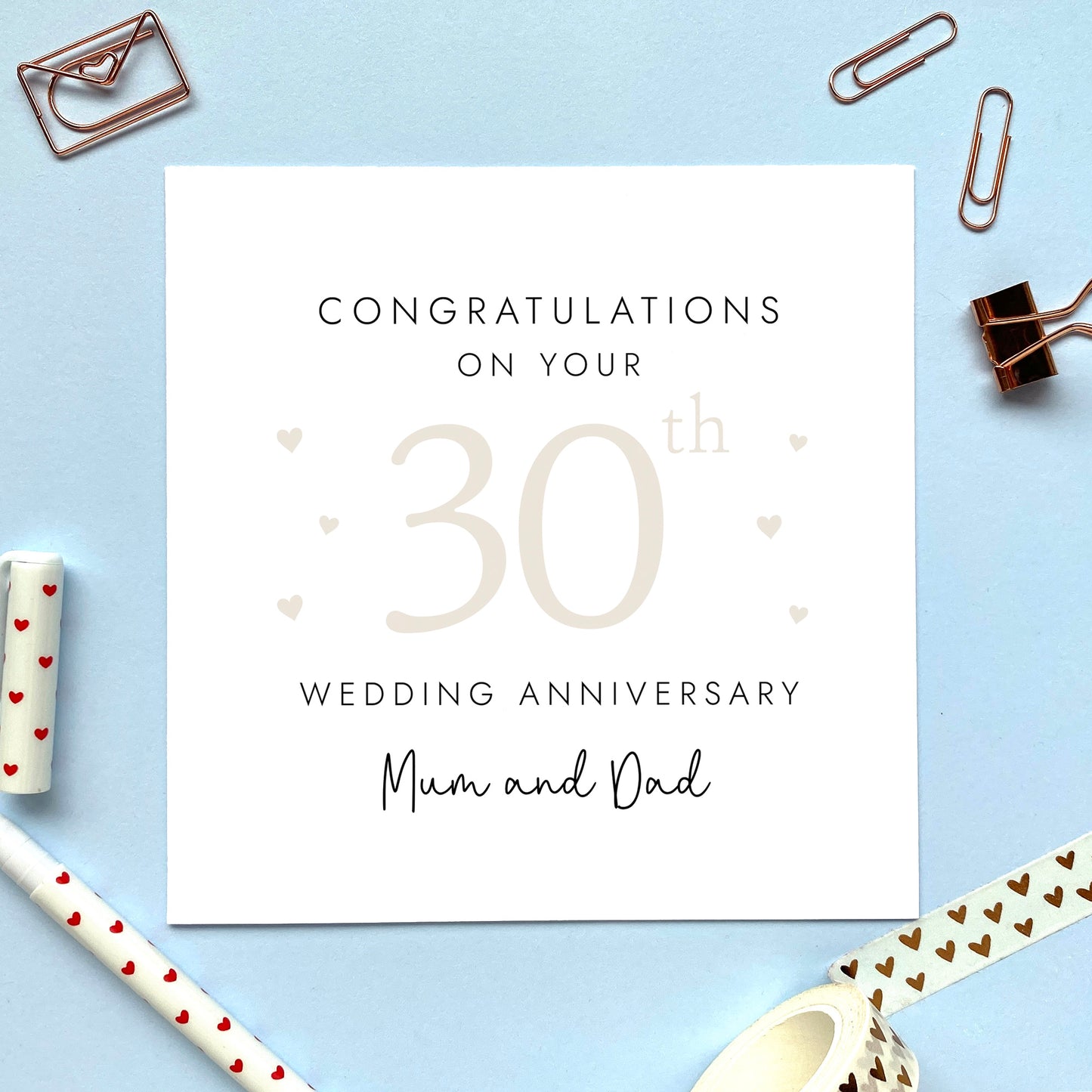 A personalised 30th wedding anniversary card for parents. It features '30th' in pale cream with hearts, the colour scheme matches the theme of pearl. The text reads 'Congratulations on your 30th wedding anniversary Mum and Dad'.