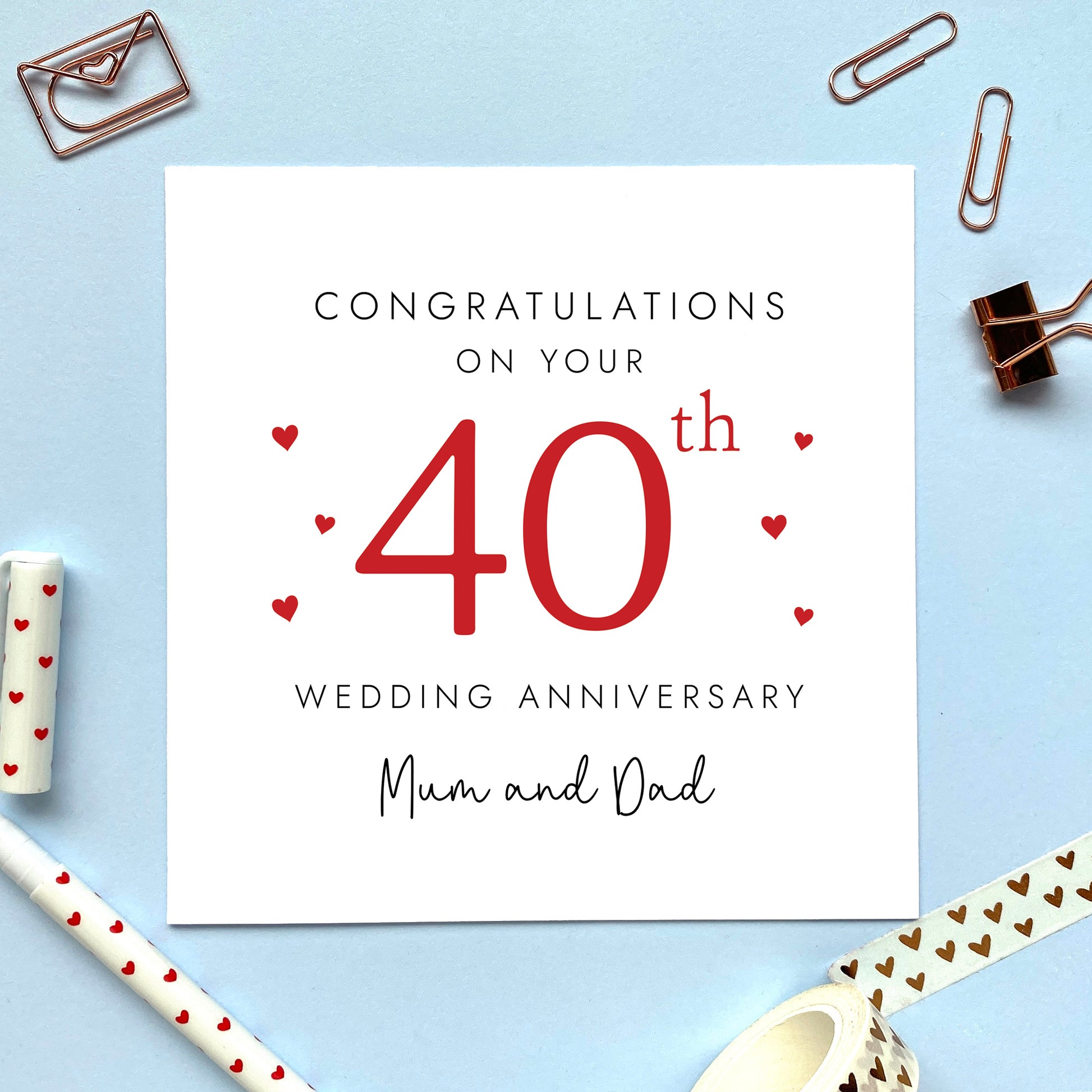 A personalised 40th wedding anniversary card for parents. It features '40th' in red with hearts, the colour scheme matches the theme of ruby. The text reads 'Congratulations on your 40th wedding anniversary Mum and Dad'. The relations can be changed to any.