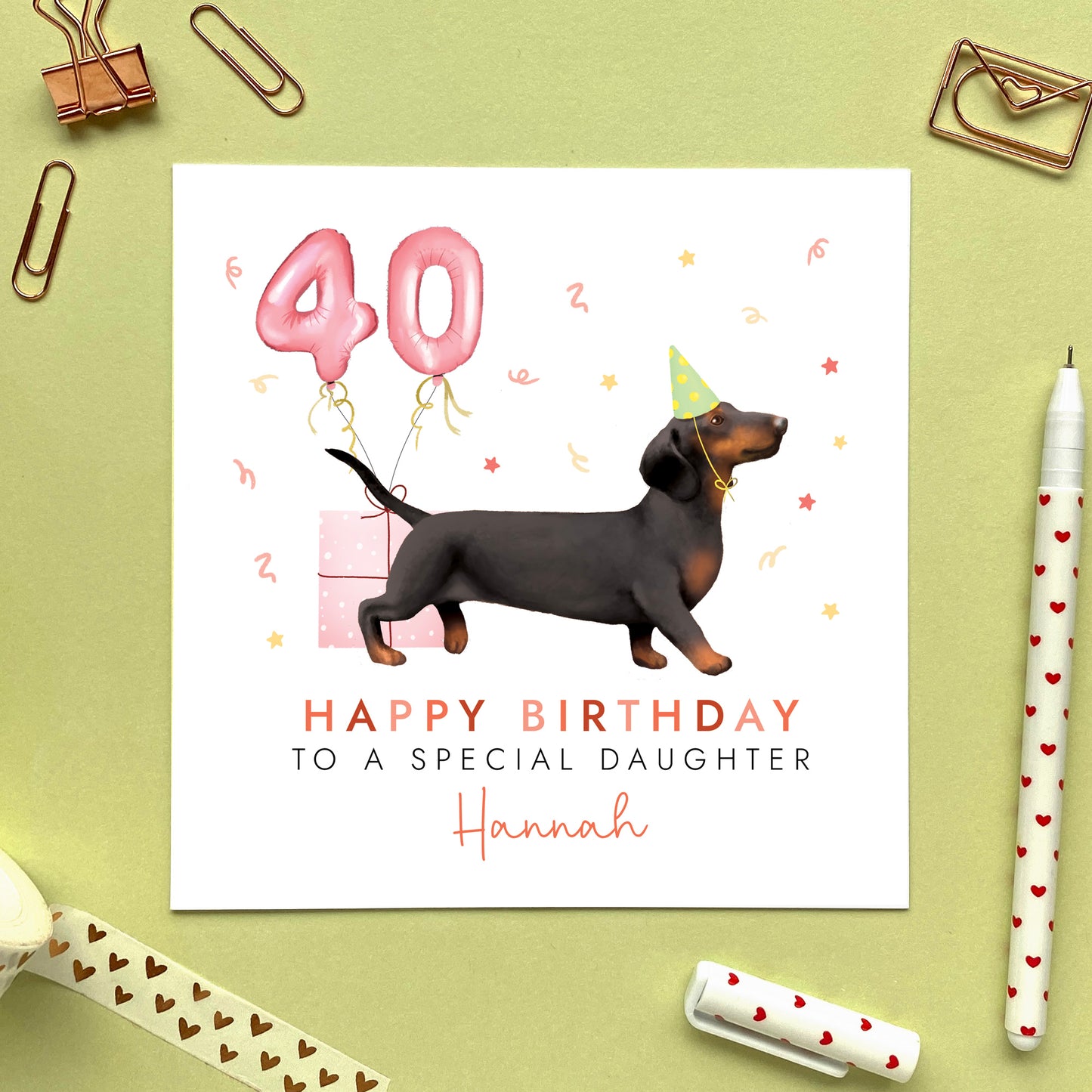 A personalised dog birthday card for her featuring a black and tan sausage dog (Dachshund). It can be personalised with any name and age. The card in the photo is a 40th birthday card for Daughter.