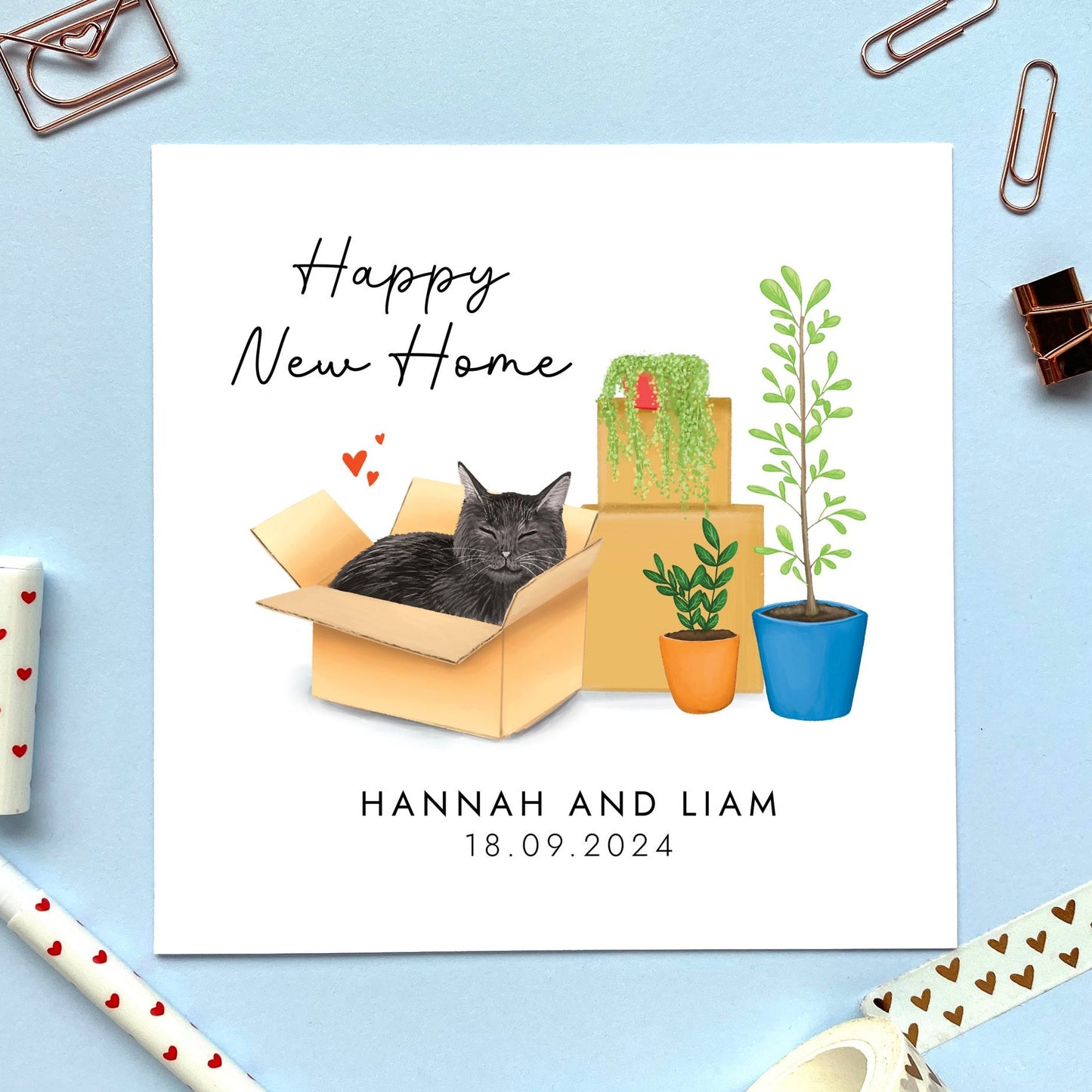 A personalised Happy New Home card featuring a black cat in a box.