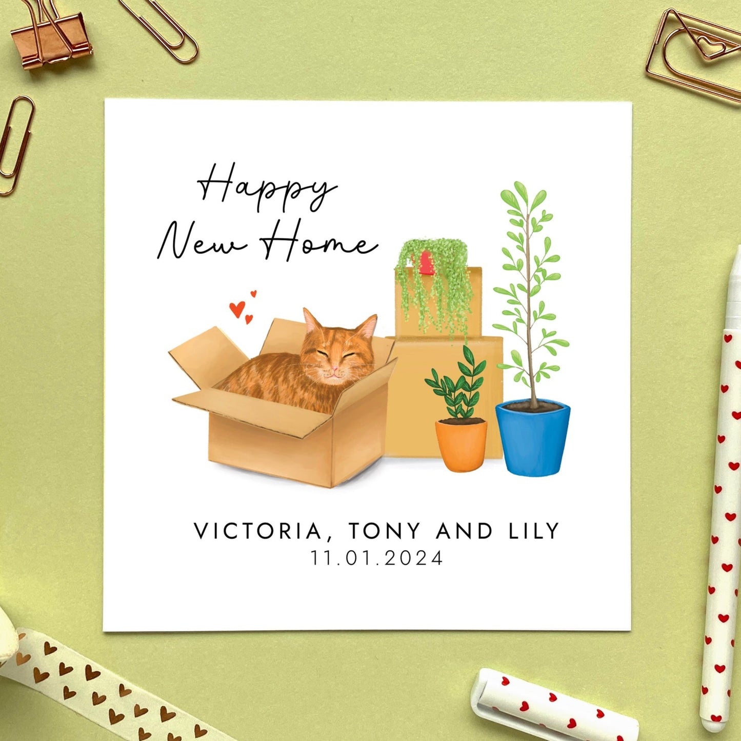 A personalised Happy New Home card featuring a ginger tabby cat in a box.