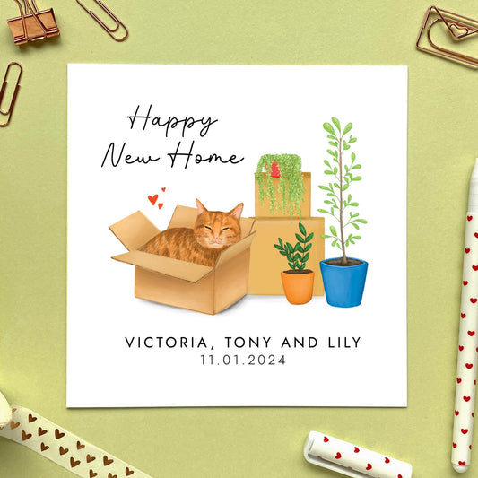 A personalised Happy New Home card featuring a ginger tabby cat in a box.