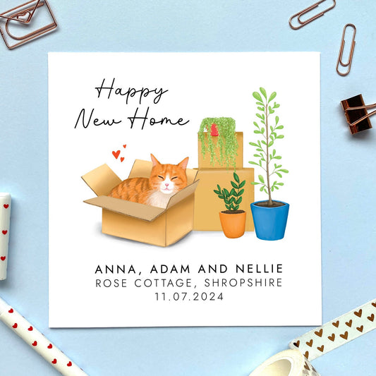 A personalised Happy New Home card featuring a ginger and white tabby cat in a box.
