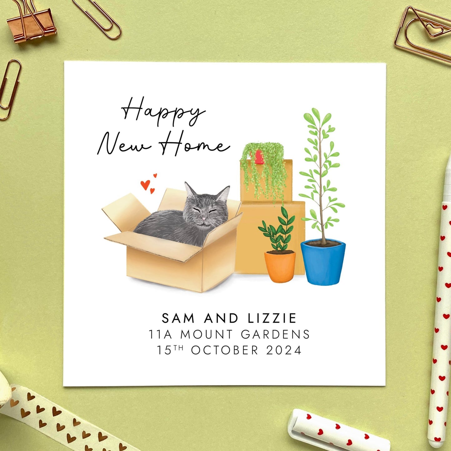 A personalised Happy New Home card featuring a grey cat in a box.