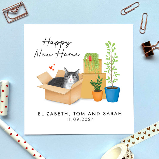 A personalised Happy New Home card featuring a silver grey tabby cat in a box.