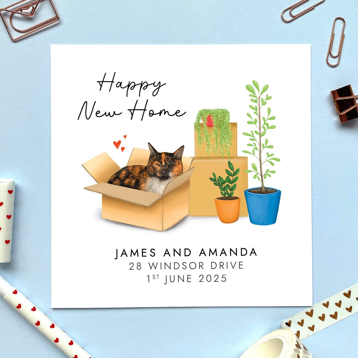 A personalised Happy New Home card featuring a tortoiseshell cat in a box.