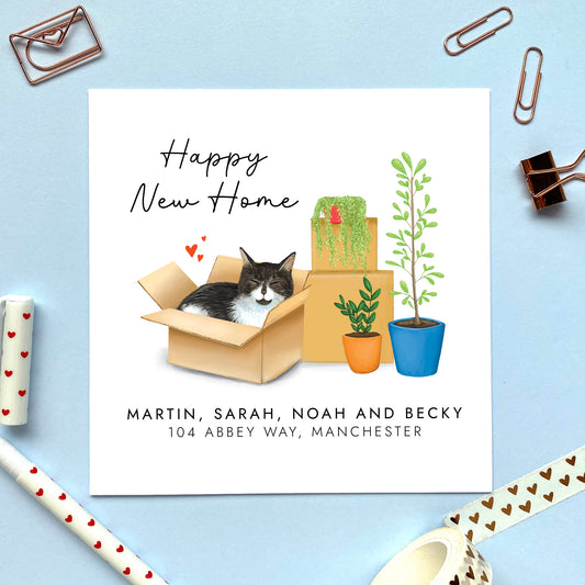 A personalised Happy New Home card featuring a black and white tuxedo cat in a box.