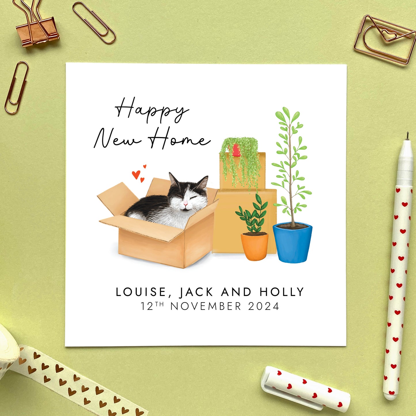 A personalised Happy New Home card featuring a black and white tuxedo cat in a box.