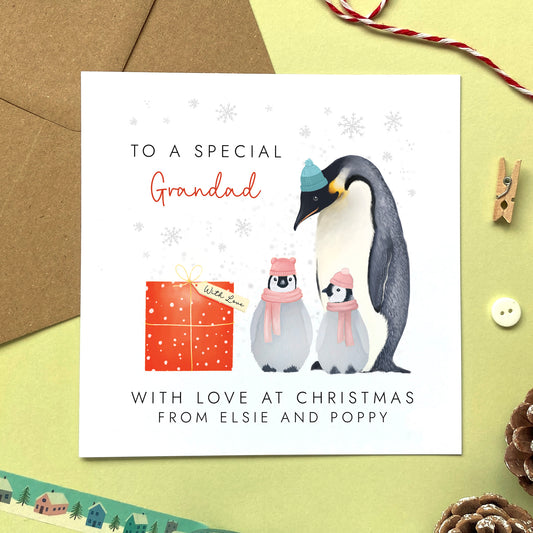 A personalised penguins Christmas Card for Grandad from two children.