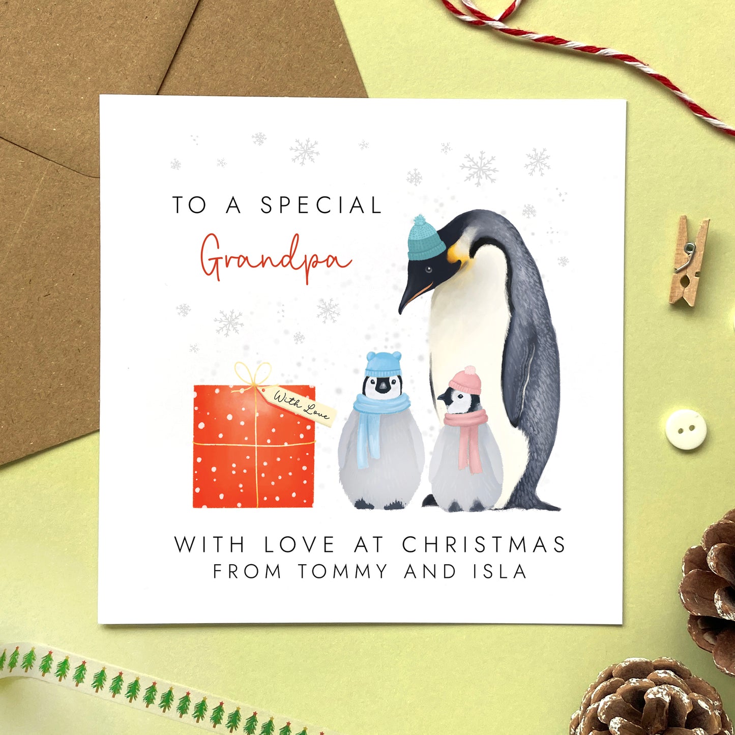 A personalised penguins Christmas Card for Grandpa from two children.