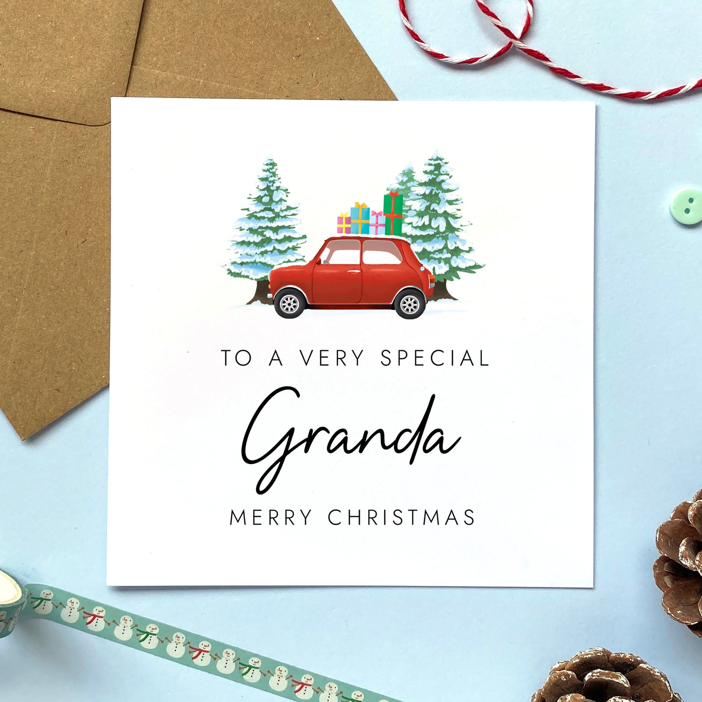 A personalised Christmas card for Granda featuring a classic red mini car, presents and fir trees.