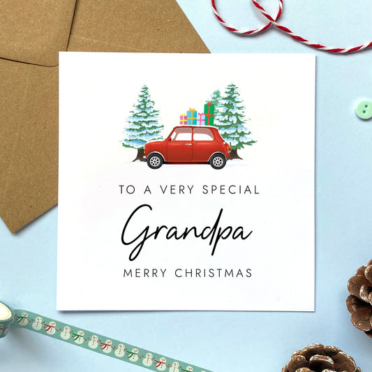 A personalised Christmas card for Grandpa featuring a classic red mini car, presents and fir trees.