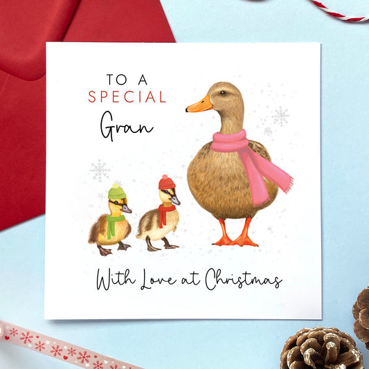 A personalised duck Christmas card for Grandmother. It features a female mallard duck next to two baby ducklings. The card in the photo is a Christmas card for a special Gran from two children.