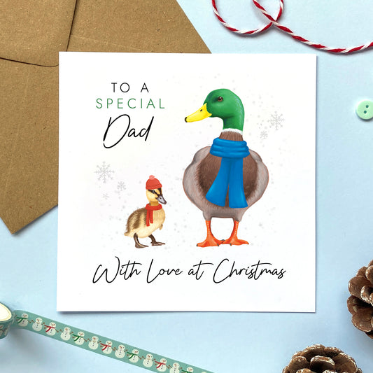 A personalised ducks christmas card for Dad. It features a male mallard duck next to a baby duckling, with the text 'To a special Dad, with love at Christmas'.