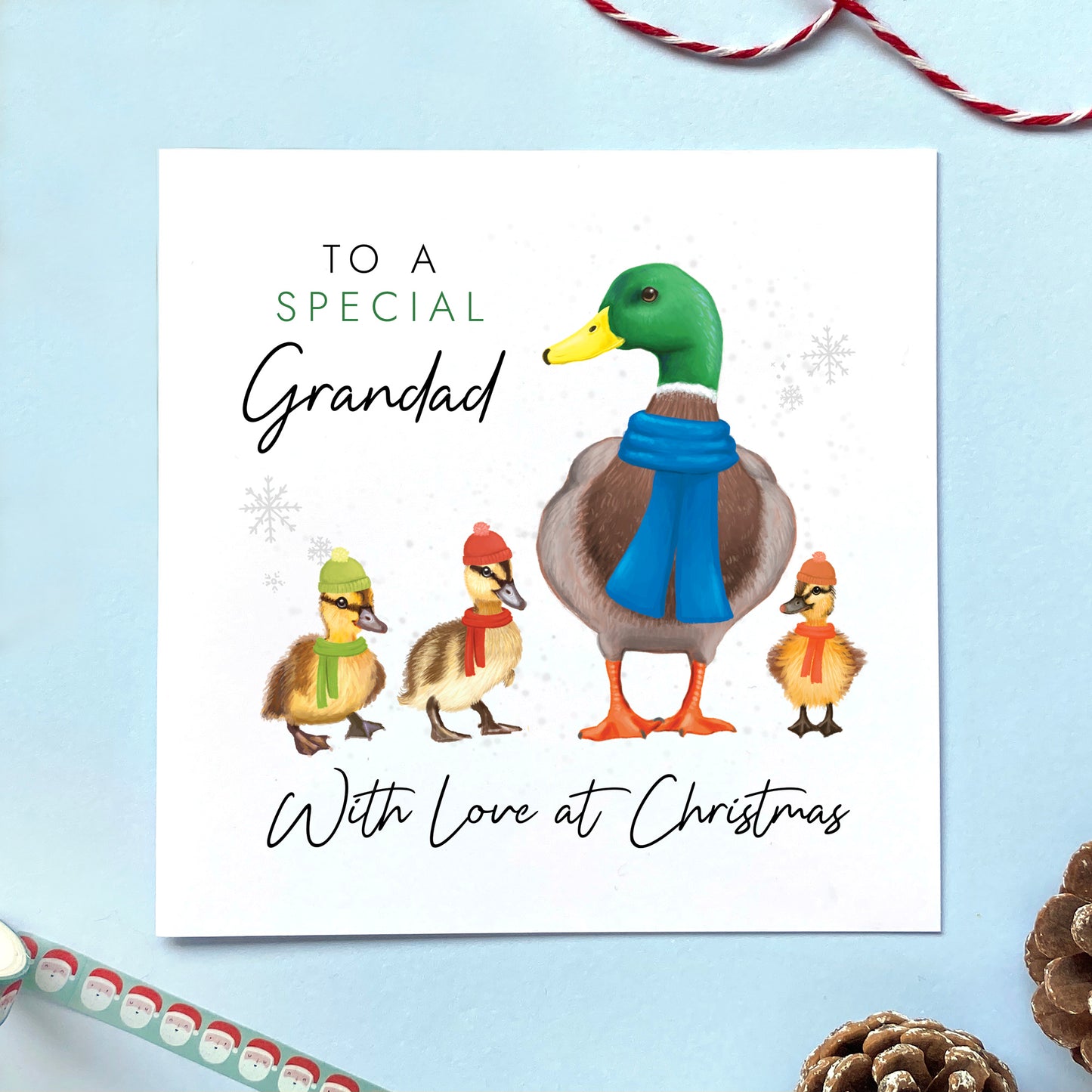 A personalised ducks christmas card for Grandad. It features a male mallard duck next to three baby ducklings or children, with the text 'To a special Grandad, with love at Christmas'.