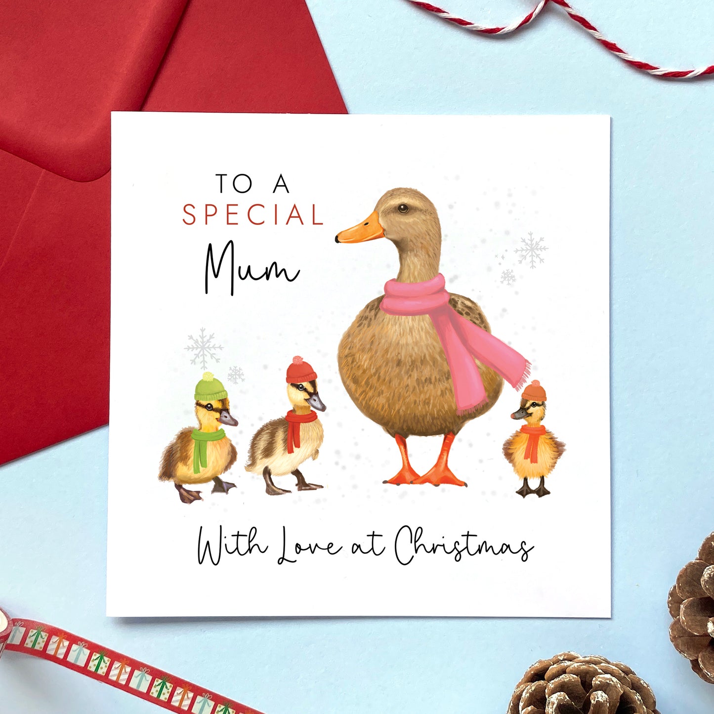A personalised ducks christmas card for Mum. It features a female mallard duck next to three baby ducklings or children with the text 'To a special Mum, with love at Christmas'.