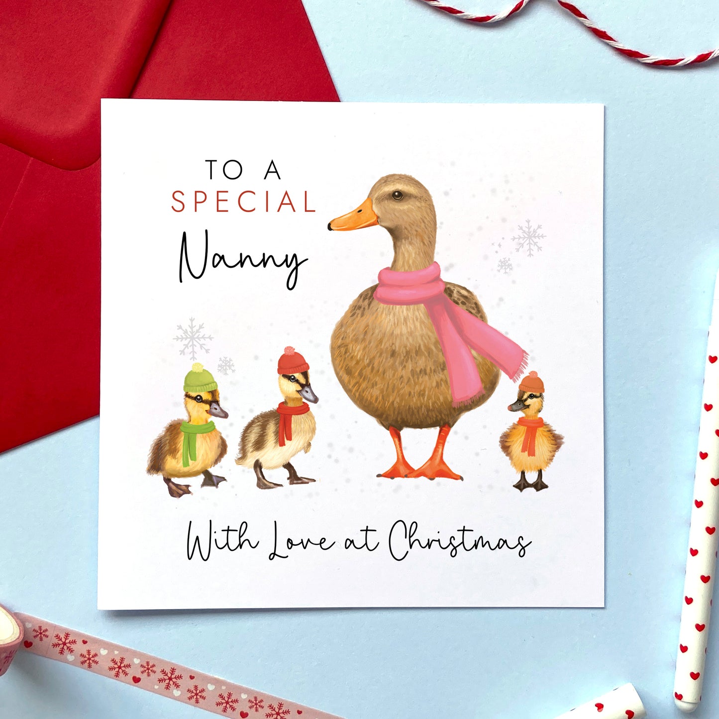 A personalised duck Christmas card for Grandmother. It features a female mallard duck next to three baby ducklings. The card in the photo is a Christmas card for a special Nanny from three children.