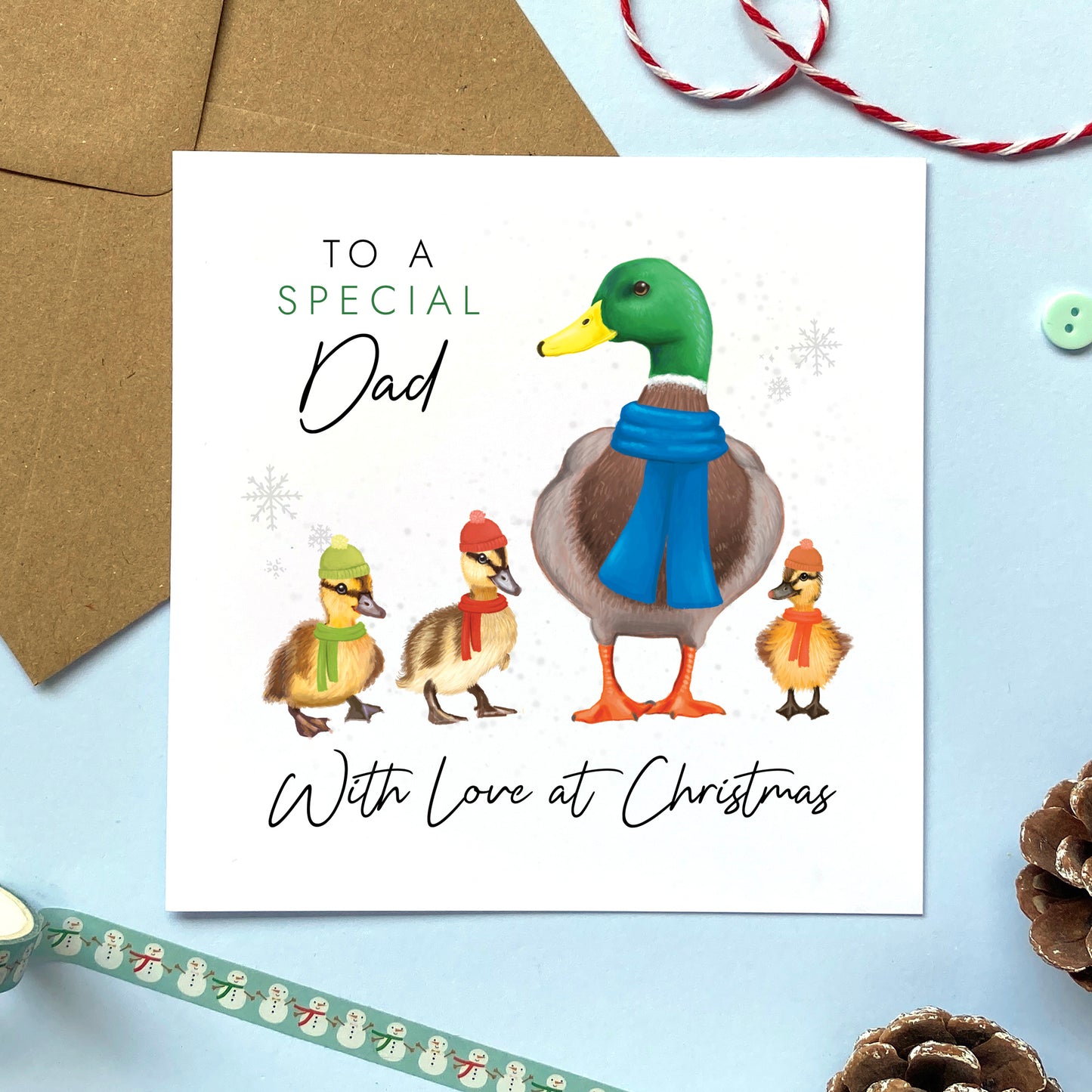 A personalised ducks christmas card for Dad. It features a male mallard duck next to three baby ducklings or children, with the text 'To a special Dad, with love at Christmas'.