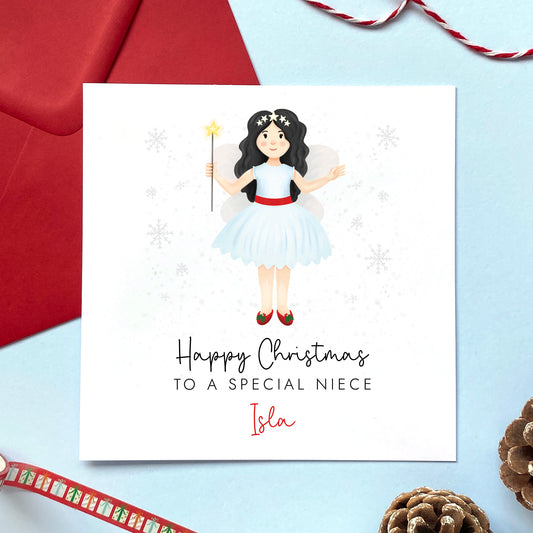 A personalised Christmas card for Niece featuring a festive themed fairy with black hair. It can be personalised with a name.