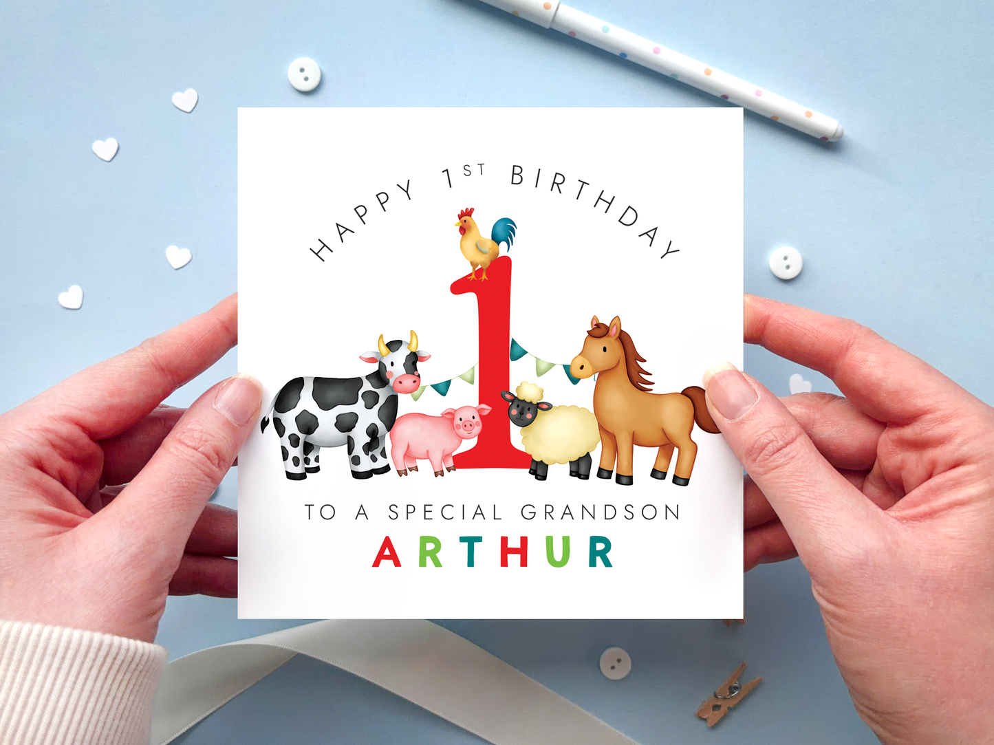 A bold and bright farm themed 1st birthday card for boys. It features a sheep, pig, cow, horse and chicken, around the number one. It can be personalised with the child's name.