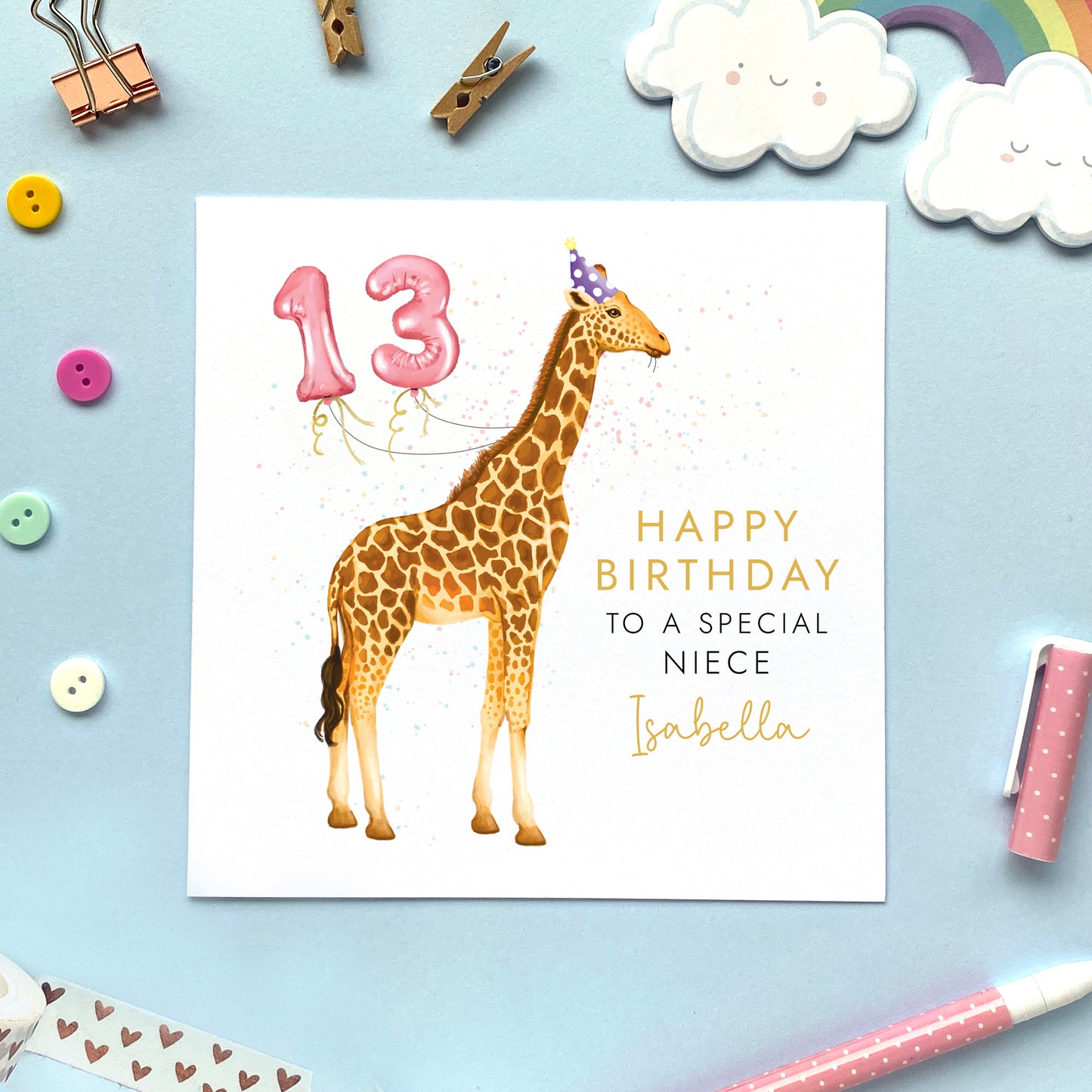 A personalised birthday card for girl featuring a giraffe. It can be personalised with a name and any age. The card in the photo is a 13th birthday card for Niece.