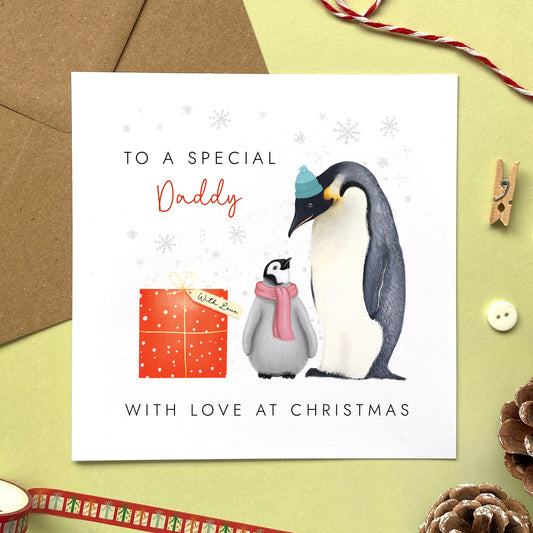 A personalsed penguins christmas card for Daddy from one child or baby girl.