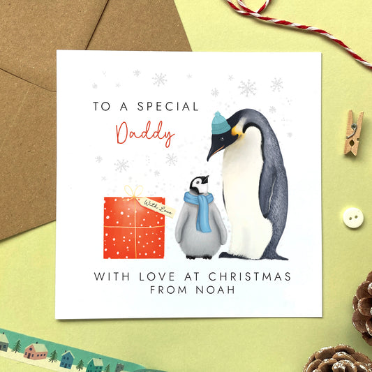A personalsed penguins christmas card for Daddy from one child or baby boy.