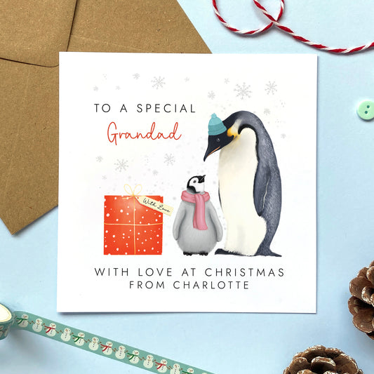 A personalsed penguins christmas card for Grandad from one child or baby.