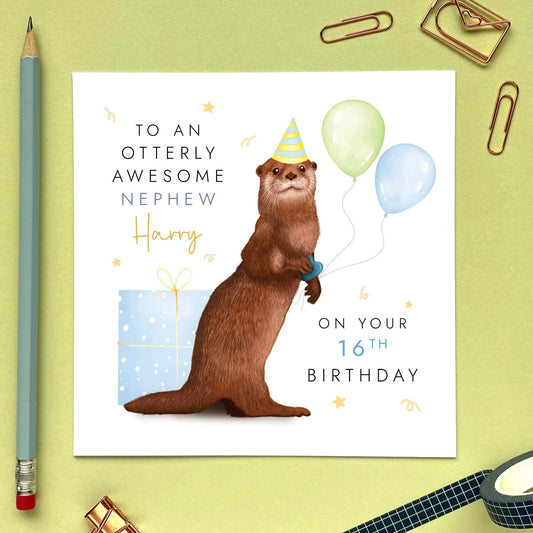 A personalised birthday card featuring a brown otter holding green and blue balloons, with a blue present. It's suitable for any age, including 1st, 2nd, 3rd, 4th, 5th, 6th and 10th. It's a good card for children, especially boys. It can be personalised with a relation, such as Son, Grandson or Nephew, and a name can also be added. The card in the photo is a 16th birthday card for Nephew.