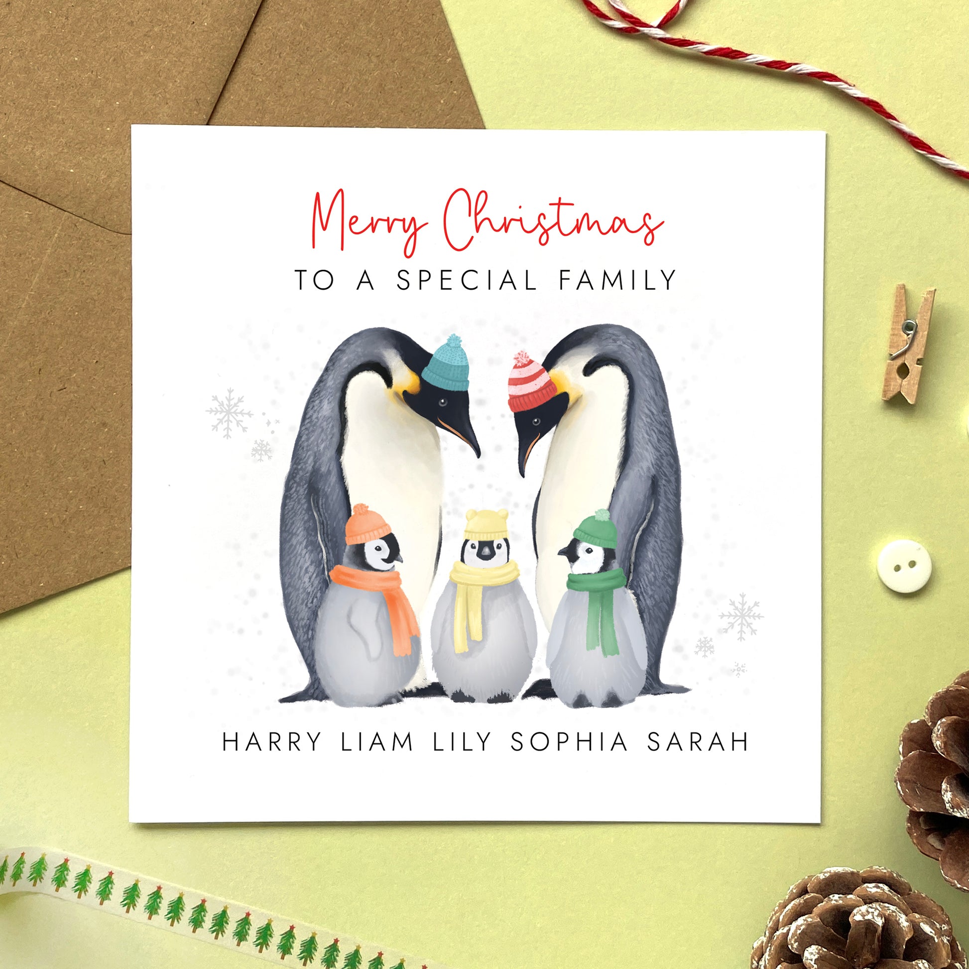 A personalised penguins Christmas Card for family with three children.