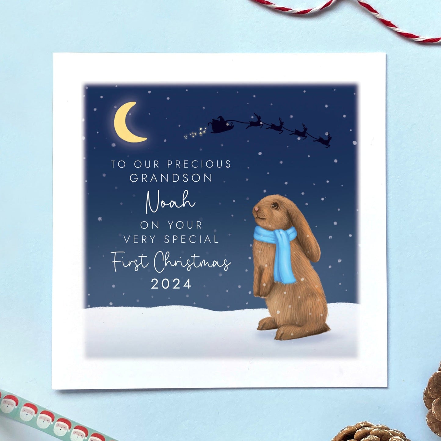 A personalised Rabbit 1st Christmas Card for Baby's First Christmas. The card in the photo is a first Christmas card for Grandson.