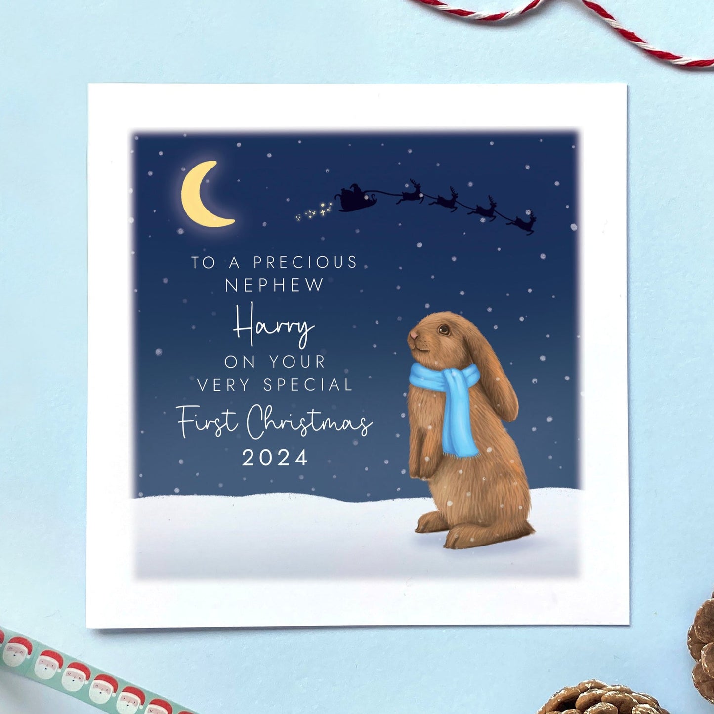 A personalised Rabbit 1st Christmas Card for Baby's First Christmas. The card in the photo is a first Christmas card for Nephew.