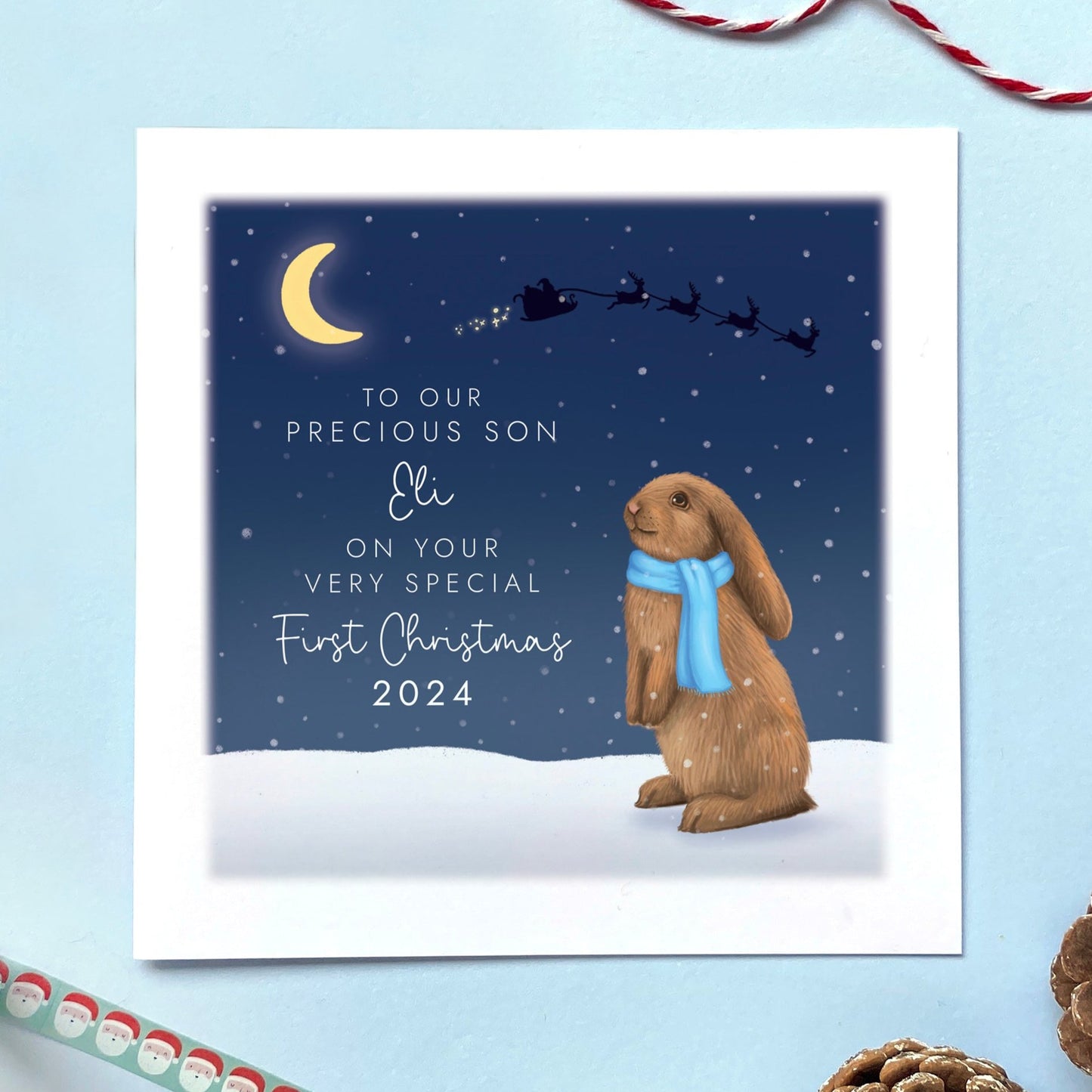 A personalised Rabbit 1st Christmas Card for Baby's First Christmas. The card in the photo is a first Christmas card for Son.
