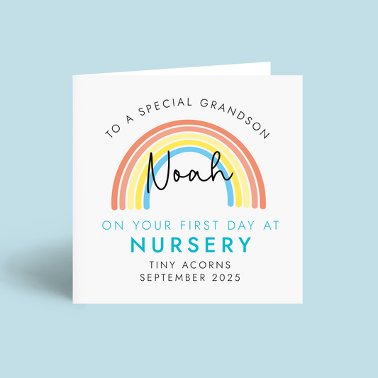 Personalised 1st day at nursery card for grandson. It features a bright rainbow with a blue theme. It can be personalised with any boy's name, school name and starting date.