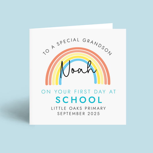Personalised 1st day at school card for Grandson. It features a bright rainbow with a blue theme. It can be personalised with any boy's name, school name and starting date.