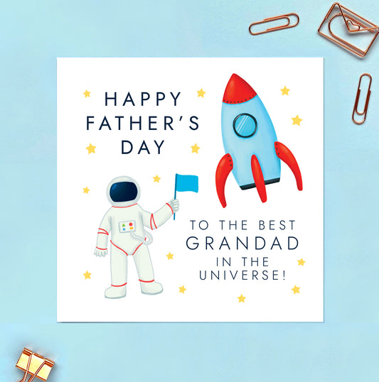 A space themed father's day card featuring a rocket and astronaut. The wording reads 'Happy Father's Day to the best Grandad in the Universe!'.