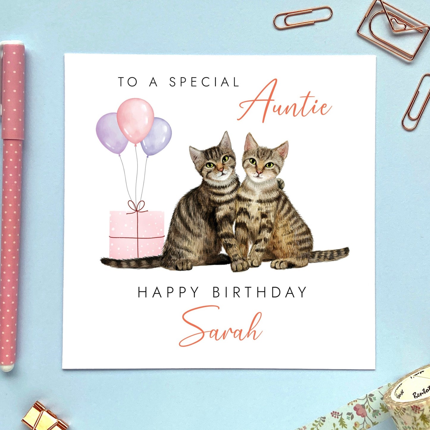 A cute personalised birthday card for Auntie featuring two tabby cats sitting next to each other. It's suitable for any Aunt, Aunty or Great Auntie. It can be personalised with any name. The age can be changed to any number such as 30th, 40th, 50th, 60th and 70th.