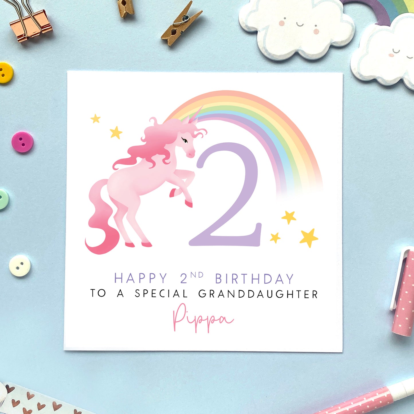 A personalised 2nd birthday card for girl featuring a pink unicorn and pastel rainbow. It's ideal for female family relations or children, such as Daughter, Granddaughter, Niece, Sister, Cousin and Little Girl. It can be personalised with a name. The card in the photo is a 2nd birthday card for granddaughter.