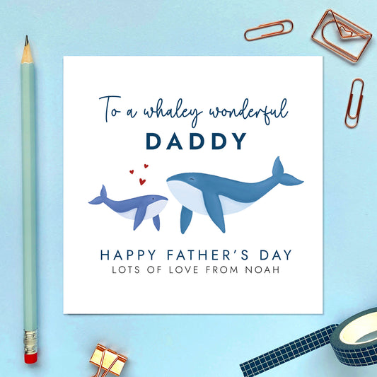 A personalised father's day card featuring a blue whale and baby whale. The wording reads 'To a whaley wonderful Daddy, Happy Father's Day'. It can be personalised with the child's name.