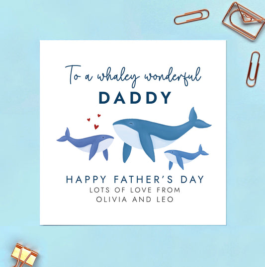 A personalised father's day card featuring a blue whale and two baby whales to represent 2 children. The wording reads 'To a whaley wonderful Daddy, Happy Father's Day'. It can be personalised with the children's names.
