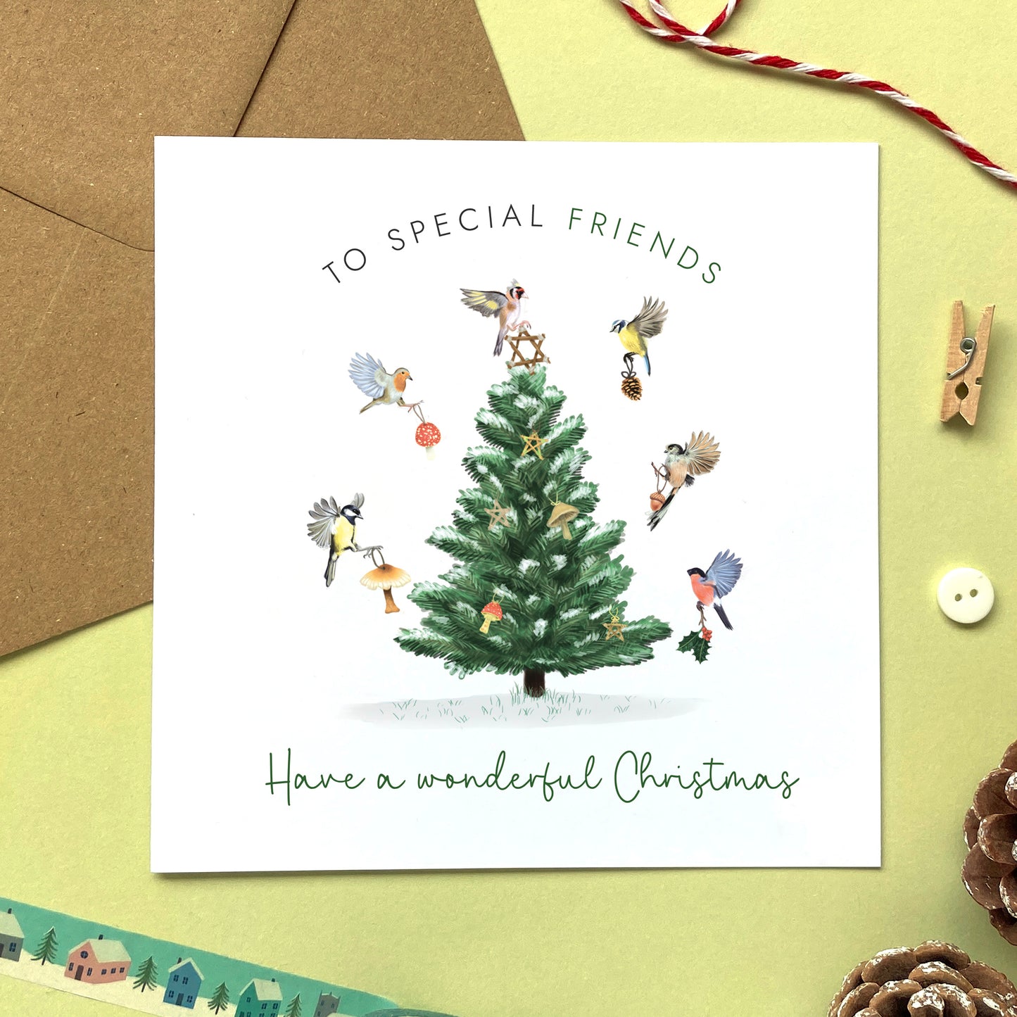 A personalised Christmas Card for Friends. It features a variety of british garden birds decorating a fir tree.