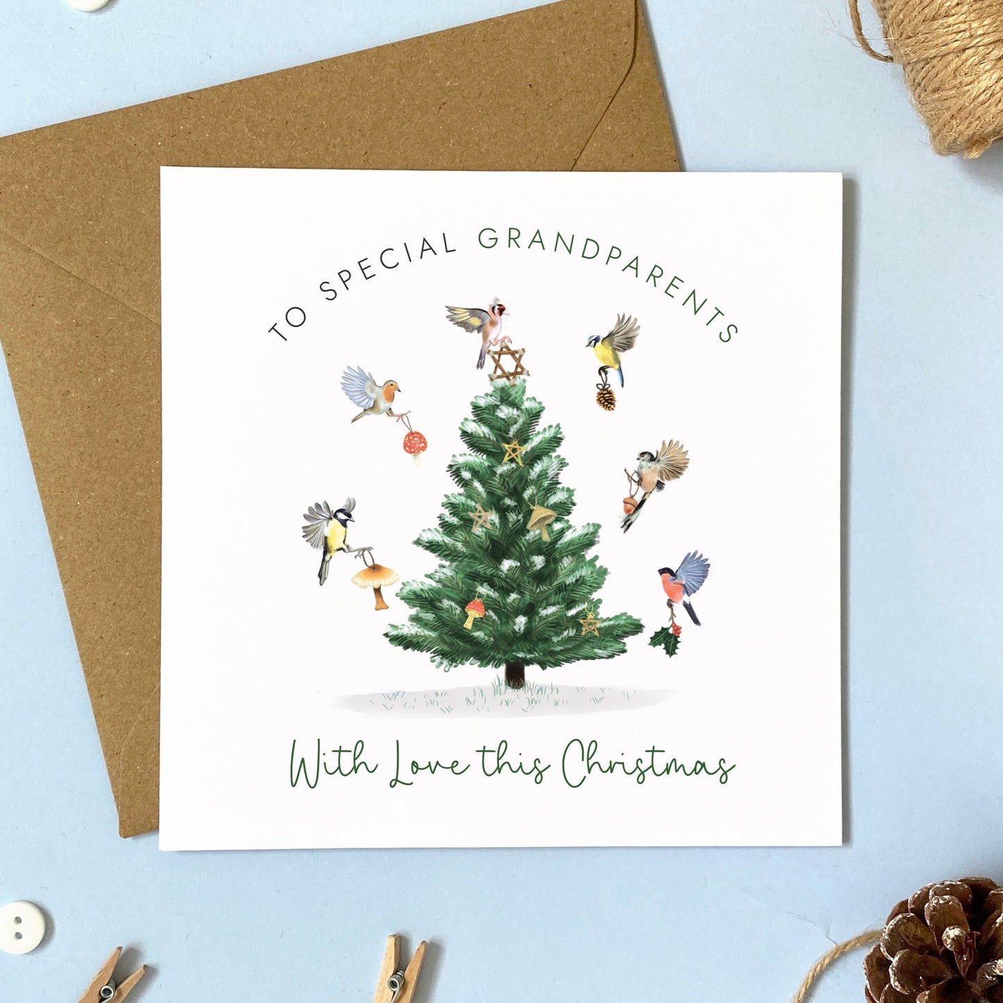 A personalised Woodland Birds Christmas Card for Grandparents. The card design has a variety of british garden birds decorating a tree.