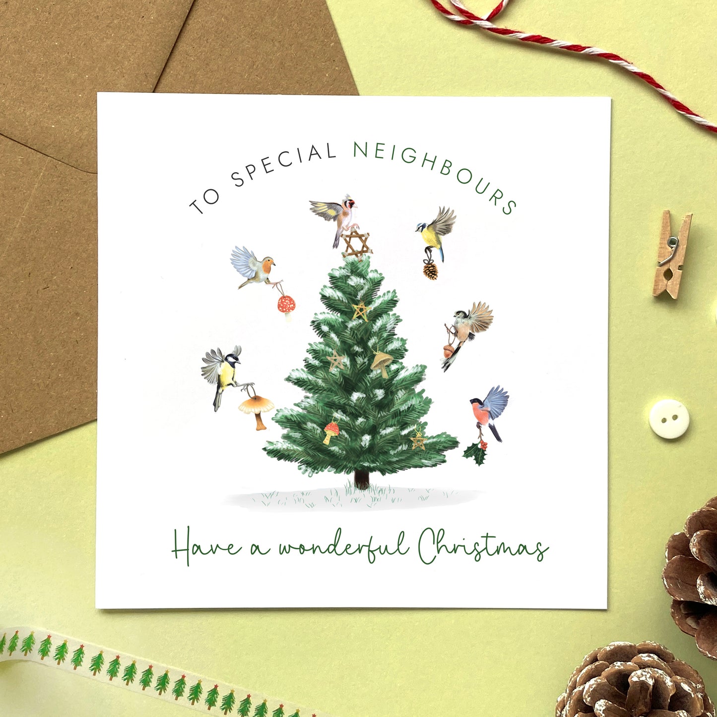 A personalised Christmas Card for Neighbours. It features a variety of british garden birds decorating a fir tree.