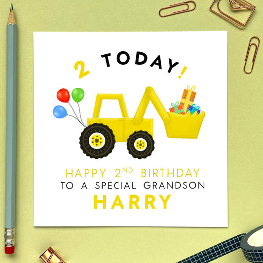 A personalised 2nd birthday card featuring a yellow digger or tractor. It's suitable for little boy, including Son, Grandson, Nephew, Brother, Cousin and Godson. It can be personalised with a name. The card in the photo is a 2nd birthday card for Grandson.
