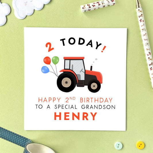 A personalised 2nd birthday card for boy featuring a red farmyard tractor. It's suitable for any little boy such as Son, Grandson, Nephew, Brother, Cousin and Godson. This card can be personalised with any child or baby's name. The card in the photo is a 2nd birthday card for Grandson.