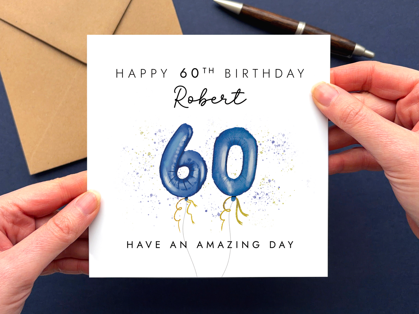 A personalised 60th birthday card for men featuring navy 60 balloons and the wording 'Happy 60th Birthday' and 'Have an amazing day'. It can be personalised with any man's name.
